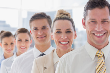 Fototapeta premium Smiling handsome businessman standing with his team