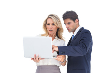 Business people looking at a laptop