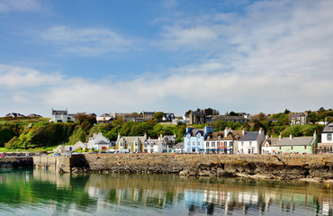 Fototapeta na wymiar Painted houses lining Portpatrick harbour
