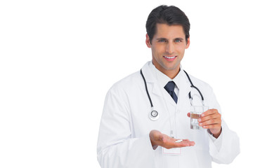 Fototapeta premium Happy doctor smiling and holding medicine