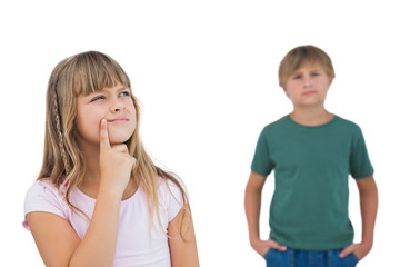 Little girl thinking with boy behind her