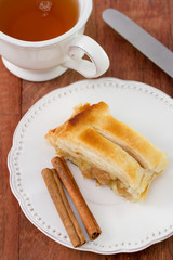 strudel on the plate with cup of tea