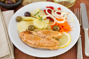 fried fish eggs with potato and salad