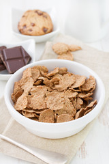 cereals in white bowl and cookies