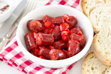 sausages in white bowl with bread