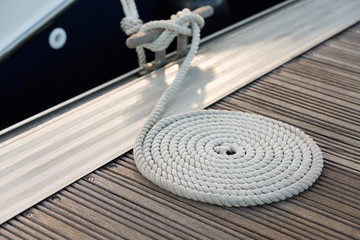 White rope coiled on a wooden dock