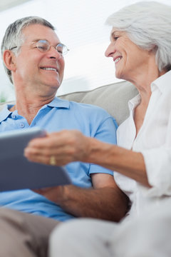 Cheerful mature couple using a digital tablet