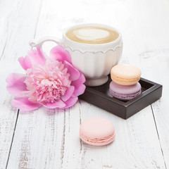 Fototapeta na wymiar French macaroons and a cup of cappuccino