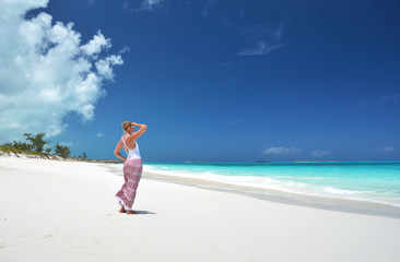 Fototapeta na wymiar Girl on the desrt beach of Little Exuma, Bahamas