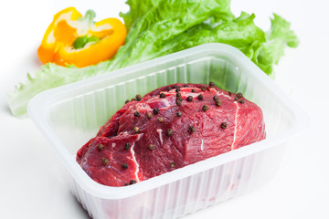 fresh raw meat and vegetables, white background