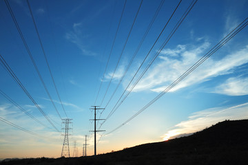 Power transmission towers at sunset