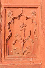 Double framed flower carved in red sandstone.