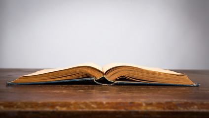 Open old vintage book on wooden table