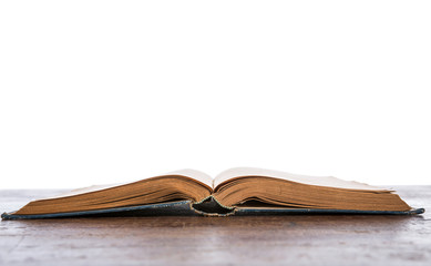 Open old vintage book on wooden table