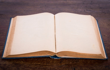 Open old vintage book on wooden background
