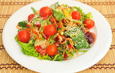 Plate with cherry tomatoes and sesame seeds.