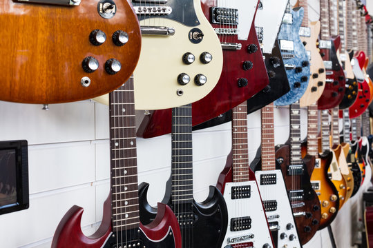Electric guitars hanging on wall in the shop