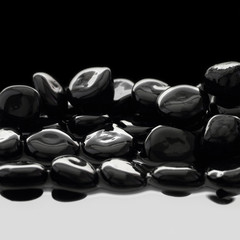 Black stones on calm water background