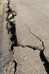 Side of the asphalt road surface crack due to ground collapsing