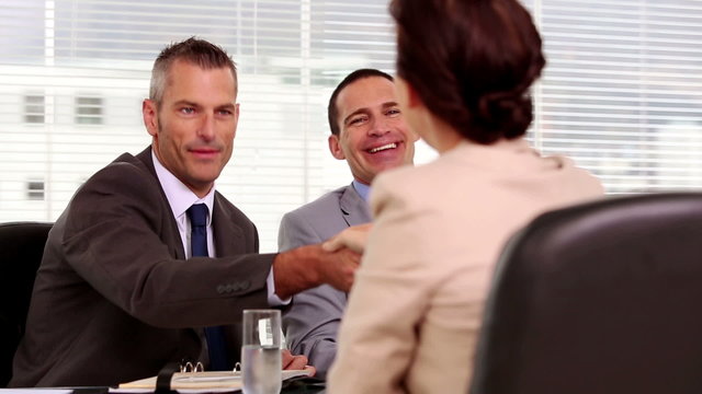 Smiling businessmen shaking hand of a job applicant
