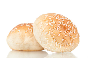 Round sandwich bun with sesame on white reflective background