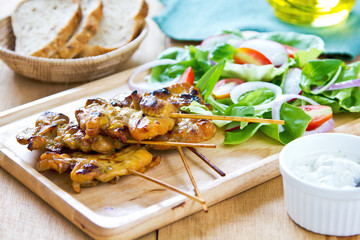 Grilled chicken skewer with salad