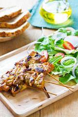 Grilled chicken skewer with salad