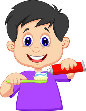 Kid squeezing tooth paste on a toothbrush