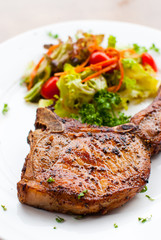 Pork chop with salad close up