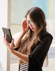 young girl uses a digital tablet