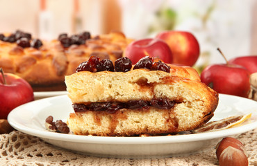 slice of tasty homemade pie with jam and apples, on wooden