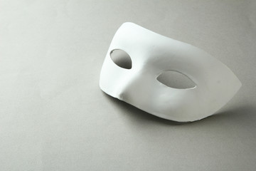 White mask, on grey background