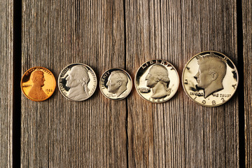 US cent coins over wooden background