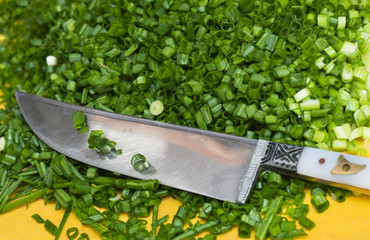 chopped green onions with a knife