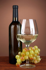 Fototapeta premium Composition of wine bottle, glass of white wine, grape