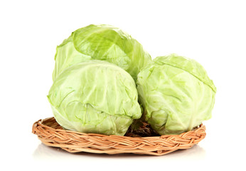 Green cabbage on wicker mat, isolated on white