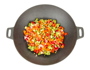 Vegetable ragout in wok, isolated on white
