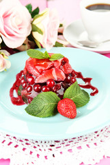 Tasty jelly dessert with fresh berries, on pink roses