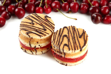 Tasty biscuit cakes and berries isolated on white