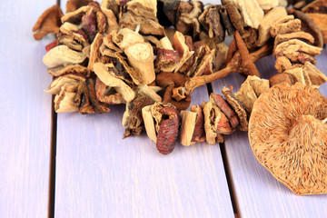 Dried mushrooms on wooden background