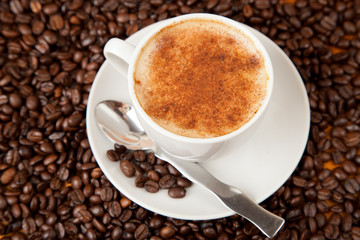 Fresh cup of coffee with cinnamon sprinkled on top