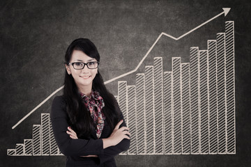Businesswoman and growing bar chart