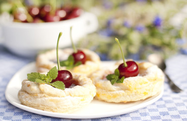 Cakes from flaky pastry with cherry