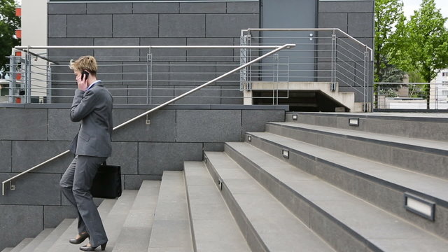 Woman in business suit walking down stairs