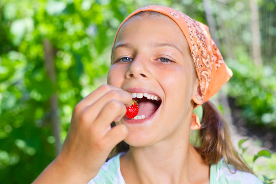 Girl eating strawberries