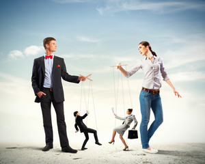 Businesspeople with marionettes