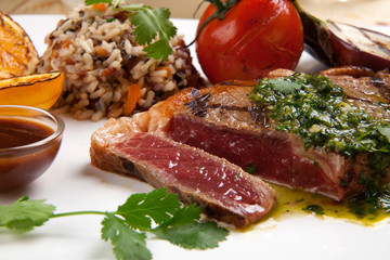 Piece of Medium Rare Steak with Spicy Herb Sauce