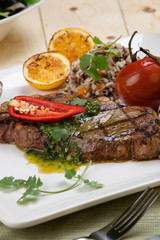 Piece of Medium Rare Steak with Spicy Herb Sauce