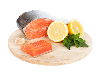 Salmon on cutting board with lemons and herbs