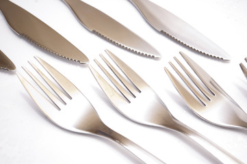 series of forks and knives against each other